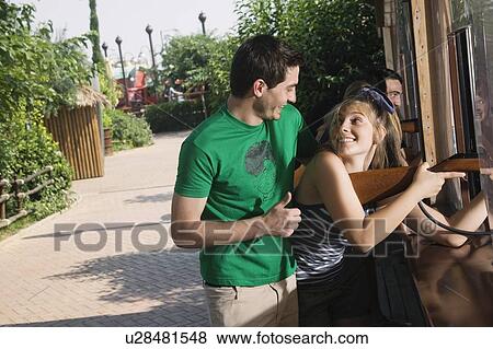 Teenage couple at game in amusement park View Large Photo Image Stock Photo - Teenage couple at game in amusement park. Fotosearch