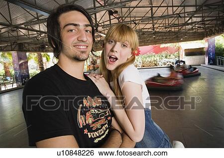 Stock Photograph - Teenage couple at game in amusement park. Fotosearch
