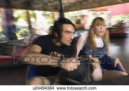 Teenage couple in bumper car in amusement park View Large Photo Image Picture - Teenage couple in bumper car in amusement park. Fotosearch