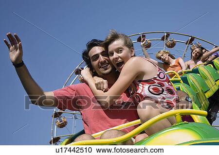 Teenage couple on amusement park ride View Large Photo Image Stock Image - Teenage couple on amusement park ride. Fotosearch