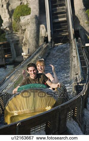 Teenage couple on amusement park ride View Large Photo Image Stock Photo - Teenage couple on amusement park ride. Fotosearch
