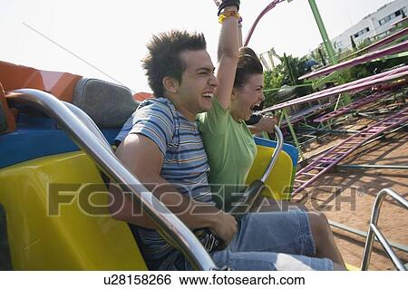 Teenage couple on amusement park ride View Large Photo Image Stock Photograph - Teenage couple on amusement park ride. Fotosearch