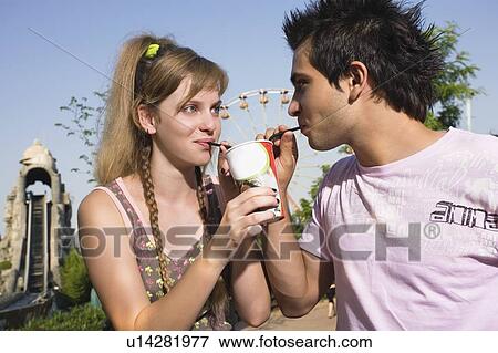 Teenage couple sharing a soda View Large Photo Image Stock Photo - Teenage couple sharing a soda. Fotosearch