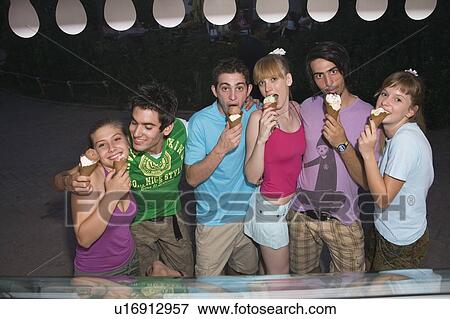 Teenagers eating ice cream View Large Photo Image Stock Photo - Teenagers eating ice cream. Fotosearch