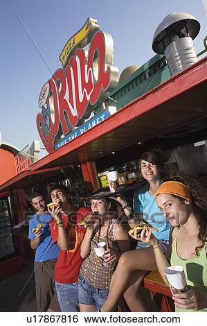 Teenagers hanging out, eating pizza View Large Photo Image Stock Photograph - Teenagers hanging out, eating pizza. Fotosearch