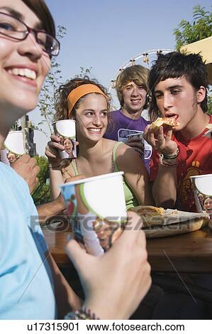 Teenagers hanging out, eating View Large Photo Image Stock Image - Teenagers hanging out, eating. Fotosearch