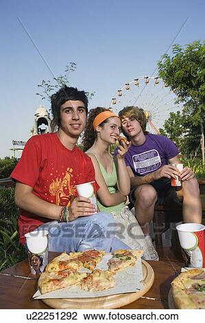 Teenagers hanging out, eating View Large Photo Image Stock Image - Teenagers hanging out, eating. Fotosearch