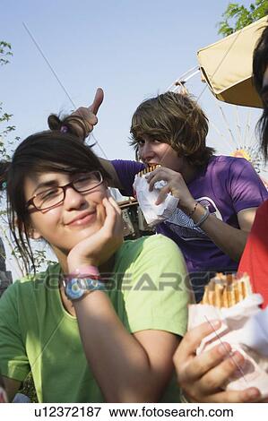 Teenagers hanging out, eating View Large Photo Image Stock Photo - Teenagers hanging out, eating. Fotosearch