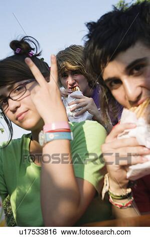 Teenagers hanging out, eating View Large Photo Image Stock Photograph - Teenagers hanging out, eating. Fotosearch