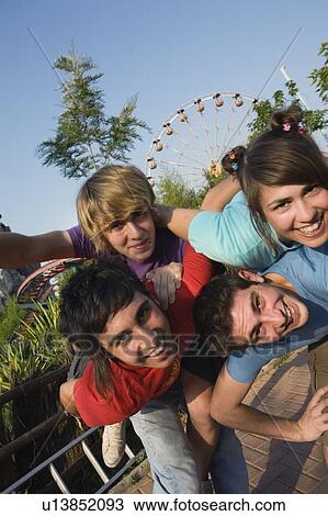Teenagers hanging out in amusement park View Large Photo Image Stock Image - Teenagers hanging out in amusement park. Fotosearch