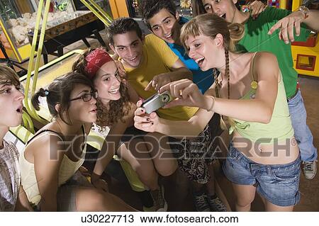 Teenagers hanging out in arcade View Large Photo Image Stock Image - Teenagers hanging out in arcade. Fotosearch
