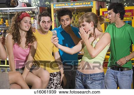 Teenagers hanging out in arcade View Large Photo Image Stock Photo - Teenagers hanging out in arcade. Fotosearch
