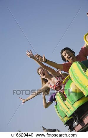 Teenagers on amusement park ride View Large Photo Image Stock Image - Teenagers on amusement park ride. Fotosearch
