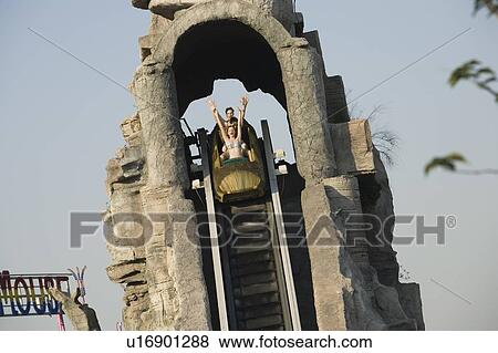 Stock Photo - Teenagers on amusement park ride. Fotosearch