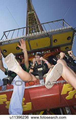 Stock Photograph - Teenagers on amusement park ride. Fotosearch