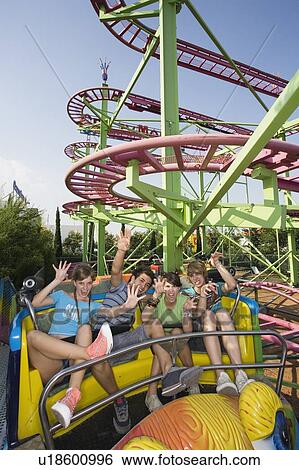 Stock Photograph - Teenagers on amusement park ride. Fotosearch