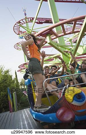 Stock Photograph - Teenagers on amusement park ride. Fotosearch