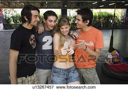 Teenagers photographing themselves in amusement park View Large Photo Image Stock Photo - Teenagers photographing themselves in amusement park. Fotosearch