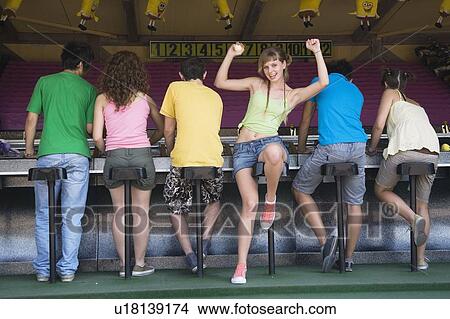 Teenagers playing game in amusement park View Large Photo Image Picture - Teenagers playing game in amusement park. Fotosearch