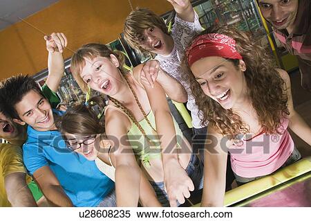 Stock Photography - Teenagers playing game in arcade. Fotosearch