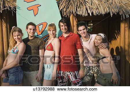 Stock Photo - Teenagers posing in amusement park. Fotosearch
