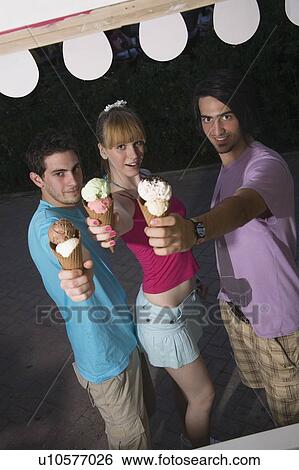 Teenagers posing with ice cream View Large Photo Image Stock Photograph - Teenagers posing with ice cream. Fotosearch