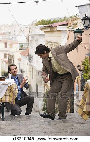 Stock Photo - Two businessmen Greek dancing. Fotosearch