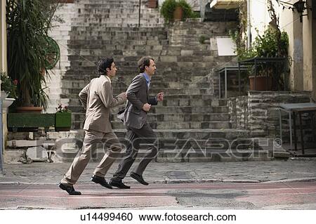 Two businessmen running View Large Photo Image Stock Image - Two businessmen running. Fotosearch