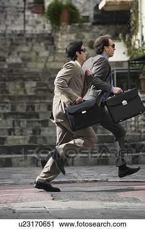 Stock Image - Two businessmen running. Fotosearch