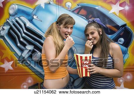 Two female teenagers posing in amusement park View Large Photo Image Stock Image - Two female teenagers posing in amusement park. Fotosearch
