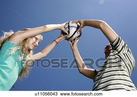 Stock Image - Boy and girl with ball. Fotosearch