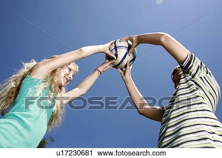 Stock Image - Boy and girl with ball. Fotosearch