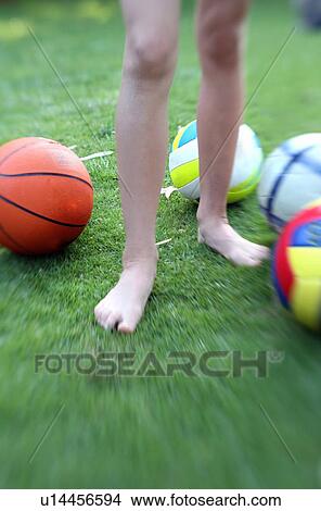 Picture - Child's legs with balls. Fotosearch