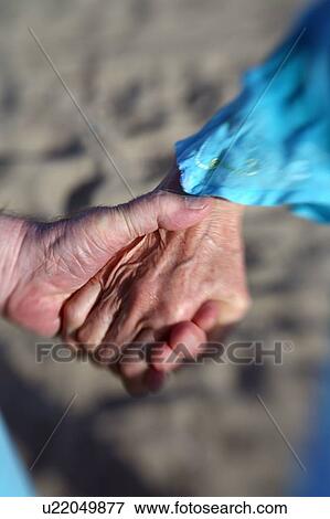 Closeup of senior couple holding hands View Large Photo Image Stock Photo - Closeup of senior couple holding hands. Fotosearch