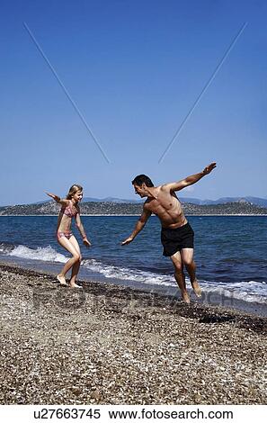 Father and daughter playing on beach View Large Photo Image Stock Photography - Father and daughter playing on beach. Fotosearch