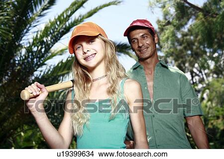 Picture - Father and daughter with baseball outfit. Fotosearch