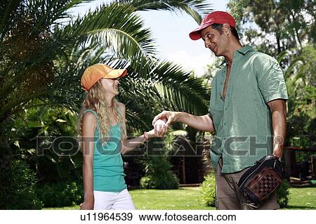 Father and daughter with baseball outfit View Large Photo Image Stock Photo - Father and daughter with baseball outfit. Fotosearch