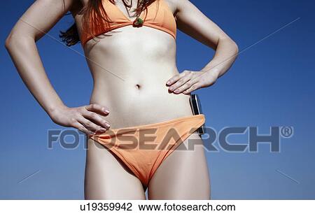 Female young adult in bikini with cell phone View Large Photo Image Stock Image - Female young adult in bikini with cell phone. Fotosearch