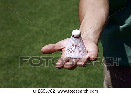 Hand holding badminton ball View Large Photo Image Stock Image - Hand holding badminton ball. Fotosearch