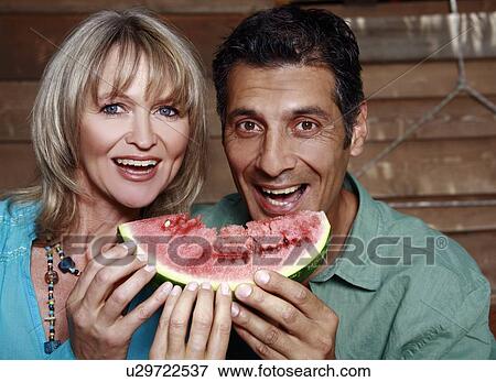 Stock Photo - Mature adult couple with watermelon. Fotosearch