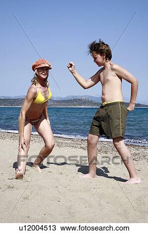 Mother and son on beach View Large Photo Image Stock Image - Mother and son on beach. Fotosearch