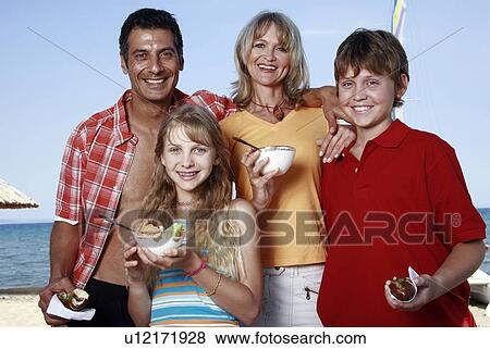 Parents with children eating at beach View Large Photo Image Stock Photo - Parents with children eating at beach. Fotosearch