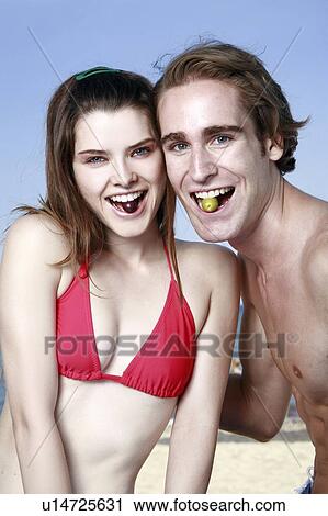 Young adult couple each with olive in mouth View Large Photo Image Stock Image - Young adult couple each with olive in mouth. Fotosearch