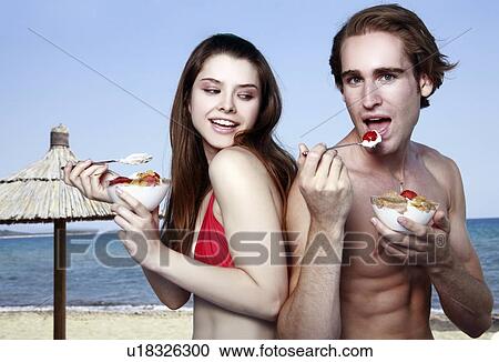 Young adult couple eating breakfast on beach View Large Photo Image Stock Image - Young adult couple eating breakfast on beach. Fotosearch