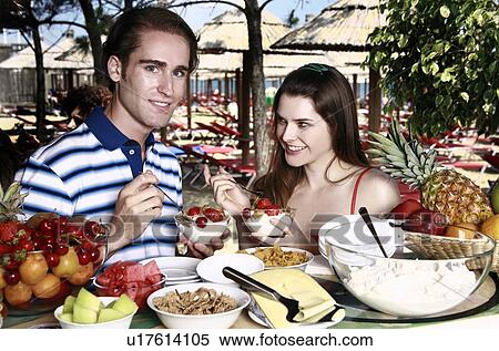 Young adult couple eating breakfast View Large Photo Image Stock Photography - Young adult couple eating breakfast. Fotosearch