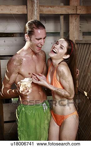 Young adult couple taking shower in bathing suits View Large Photo Image Stock Image - Young adult couple taking shower in bathing suits. Fotosearch