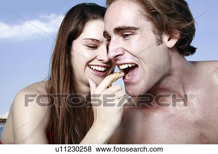 Young man eating honey from young woman's finger View Large Photo Image Stock Photo - Young man eating honey from young woman's finger. Fotosearch