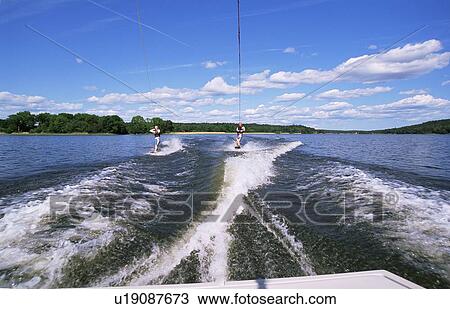 Stock Image - 2 people water skiing. Fotosearch