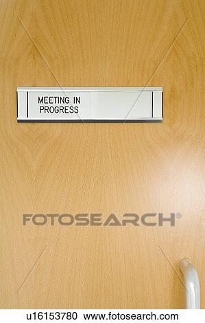 Stock Image - A Closed Office Door, With 'Meeting In Progress' Sign. Fotosearch