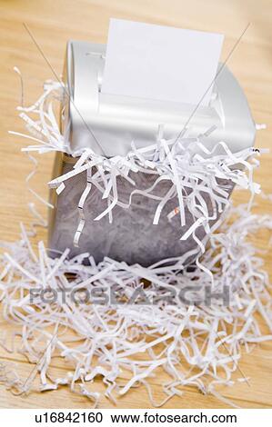 Stock Image - An Overflowing Paper Shredder. Fotosearch
